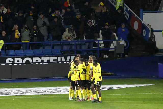 Watford's Jaoa Pedro (hidden) celebrates scoring his side's first goal of the game with team-mates in front of the fans during the Sky Bet Championship match at John Smith's Stadium, Huddersfield. Picture: Will Matthews/PA Wire.
