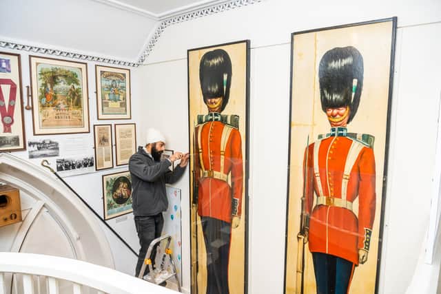 Pictured Amarjit Singh, Collection Assistant securing the Rex Whistler artwork after it's been repositioned in the museum. Rex served in the Welsh Guards during the Second World War. During the christmas of 1943 his battalion decided to give a party for the young people of Pickering on Christmas Eve, 1943. Over 294 children attended the event held in the Memorial Hall within the Town. Rex painted the room with images of Father Christmas on his sledge, children ice skating and eating cakes. On either side of the stage he painted life size artwork of Welsh Guardsmen, the battalion band played carols and after tea there was a Punch and Judy show and a conjurer. Unfortunately on July 18th in the battlion's first encounter with the enemy, Rex Whilster was the first fatal casualty.Picture By Yorkshire Post Photographer,  James Hardisty.