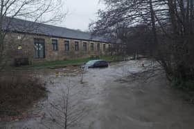 A car was stranded due to flooding after a member of the public was rescued.