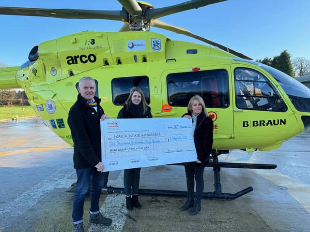 Mark and Carol presenting a cheque to the Yorkshire Air Ambulance