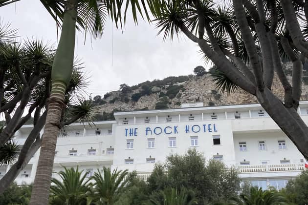 The Rock Hotel built into the cliffside, and towering above the Alameda Botanical Gardens.