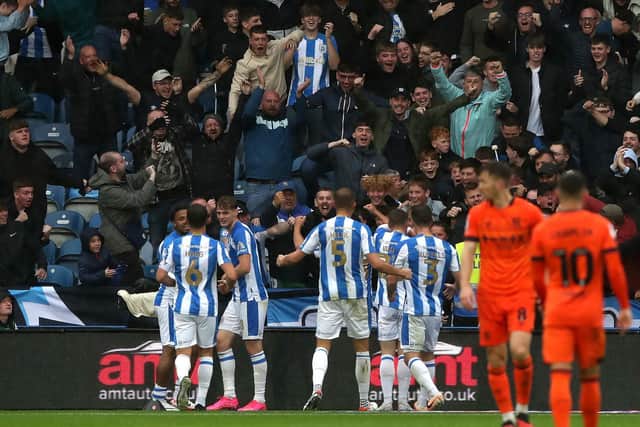 Huddersfield Town's Delano Burgzorg celebrates scoring their side's first goal of the game with team-mates during the Sky Bet Championship match at John Smith's Stadium, Huddersfield. Picture date: Saturday September 30, 2023. PA Photo. See PA story SOCCER Huddersfield. Photo credit should read: Tim Markland/PA Wire

RESTRICTIONS: EDITORIAL USE ONLY No use with unauthorised audio, video, data, fixture lists, club/league logos or "live" services. Online in-match use limited to 120 images, no video emulation. No use in betting, games or single club/league/player publications.
