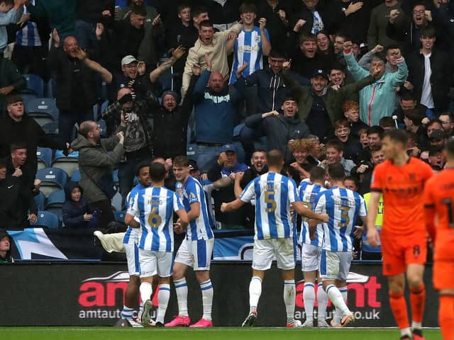 Huddersfield Town's Delano Burgzorg celebrates scoring their side's first goal of the game with team-mates during the Sky Bet Championship match at John Smith's Stadium, Huddersfield. Picture date: Saturday September 30, 2023. PA Photo. See PA story SOCCER Huddersfield. Photo credit should read: Tim Markland/PA WireRESTRICTIONS: EDITORIAL USE ONLY No use with unauthorised audio, video, data, fixture lists, club/league logos or "live" services. Online in-match use limited to 120 images, no video emulation. No use in betting, games or single club/league/player publications.