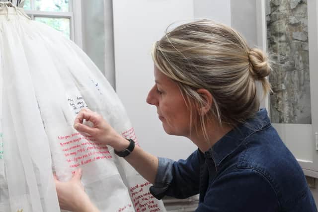 Textile artist Hannah Lamb working on her installation Fragments of a Dress at the Bronte Parsonage Museum.