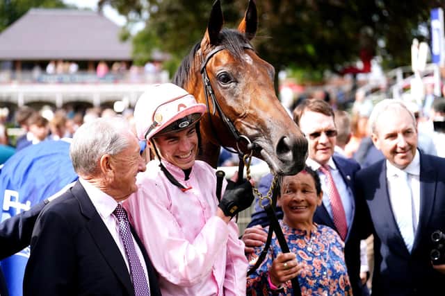 EDGING AHEAD: Co-owner Derrick Smith (left) and jockey James Doyle pose with Warm Heart after winning the Pertemps Network Yorkshire Oaks on day two of the Sky Bet Ebor Festival at York. Picture: Mike Egerton/PA