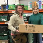 Welcome Centre warehouse manager Jess Johnstone (left) and volunteer Jo Pearce with another box of 20 FloodSax alternative sandbags.