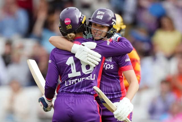 OPENING SALVO: Northern Superchargers' Phoebe Litchfield (left) and Alice Davidson-Richards celebrate winning their opening match in The Hundred against visitors Birmingham Phoenix at Headingley on Thursday night. Picture: Danny Lawson/PA