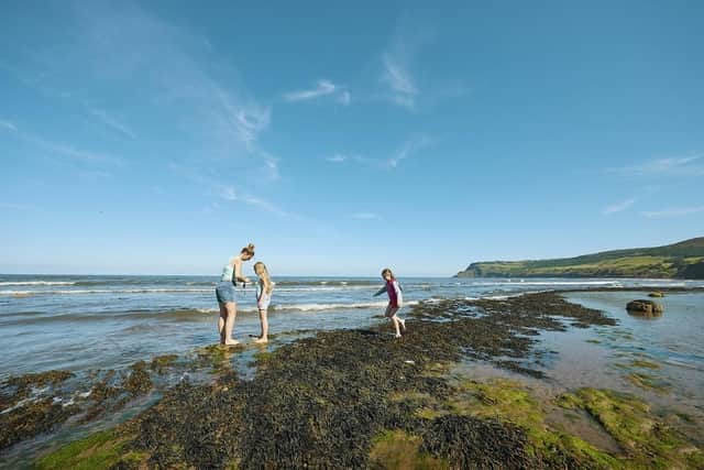 Visitors paddling on the beach at Robin Hood's Bay. (Pic credit: Trevor Hart / National Trust Images)