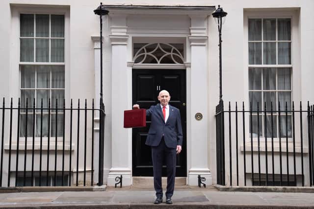 Chancellor John Healey poses for photographs as he leaves 11 Downing Street, London, before delivering his first Budget. PIC: Stefan Rousseau/Press Association