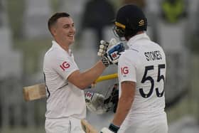 RISING STAR: England's Harry Brook, left, is congratulated by Ben Stokes after scoring century against Pakistan in Rawalpindi. The Yorkshire batsman has been picked to face South Africa. Picture: AP Photo/Anjum Naveed