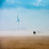 As the cold sea fret lifts from the Bridlington beach silhouettes of people playing, walking and metal detecting on the beach are just visible.
Picture By Yorkshire Post Photographer,  James Hardisty. Date: 6th May 2023.