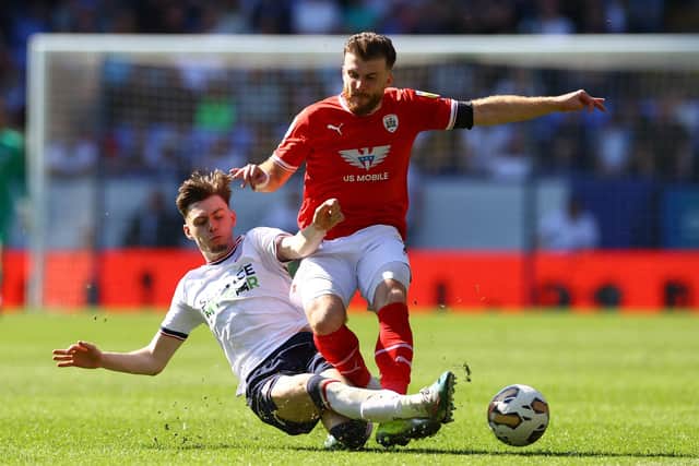 TOUGH GOING: Barnsley's Nicky Cadden tackles Bolton Wanderers' Conor Bradley during Saturday's play-off semi-final first leg. Picture: Michael Steele/Getty Images)