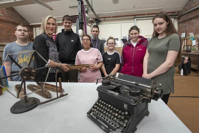 Heritage officer Alison McMaster, second left, at the Sunny Bank Mills Archive with students and staff at West SILC. Picture: Giles Rocholl Photography
