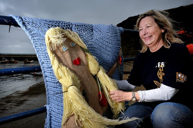 Jacqueline Power arranges the knitted mermaid on the seafront