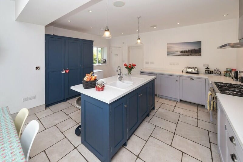 The kitchen features handbuilt cabinetry and underfloor heating