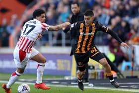 HULL, ENGLAND - MARCH 29: Anass Zaroury of Hull City is challenged by Ki-Jana Hoever of Stoke City during the Sky Bet Championship match between Hull City and Stoke City at MKM Stadium on March 29, 2024 in Hull, England. (Photo by George Wood/Getty Images)