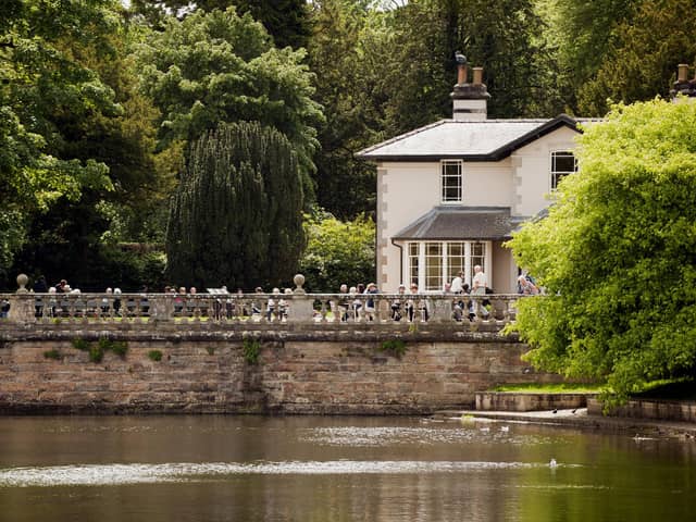 Visitors at the Victorian tea-room beside the lake at Studley Royal Water Garden, North Yorkshire.