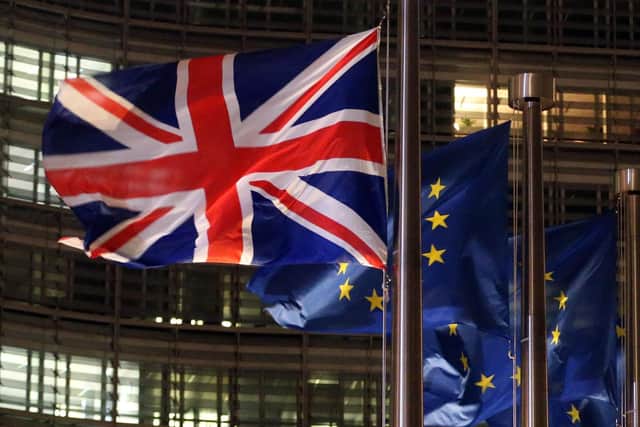A picture taken on December 9, 2020 shows a flag of the an Union Jack and European flags fluttering outside the Berlaymont building, the European commission headquarters. PIC: FRANCOIS WALSCHAERTS/AFP via Getty Images
