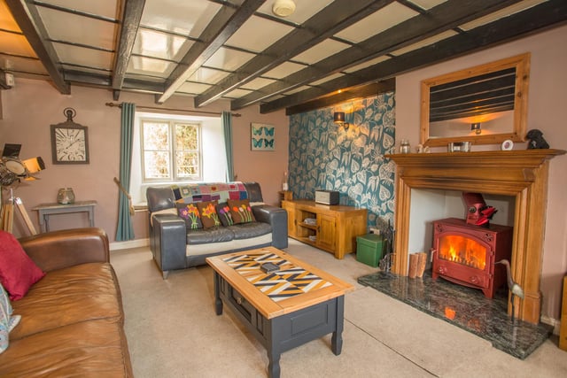 One of the cosy sitting rooms with a wood-burning stove