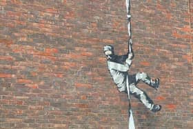 Banksy has yet to confirm whether he painted the prisoner escaping on the HMP Reading wall (Picture: BBC)