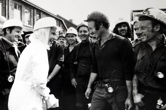 The late Queen with a group of miners. Picture by John Varley.