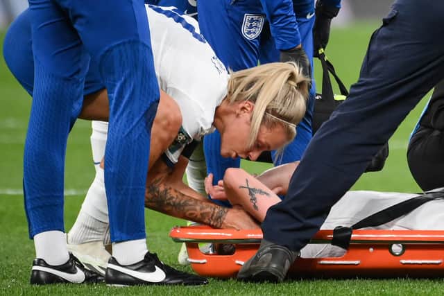 England's midfielder Keira Walsh (C) is comforted by England's forward Rachel Daly (L) as she is taken off on a stretcher after an injury during the Australia and New Zealand 2023 Women's World Cup Group D match between England and Denmark (Picture: FRANCK FIFE/AFP via Getty Images)
