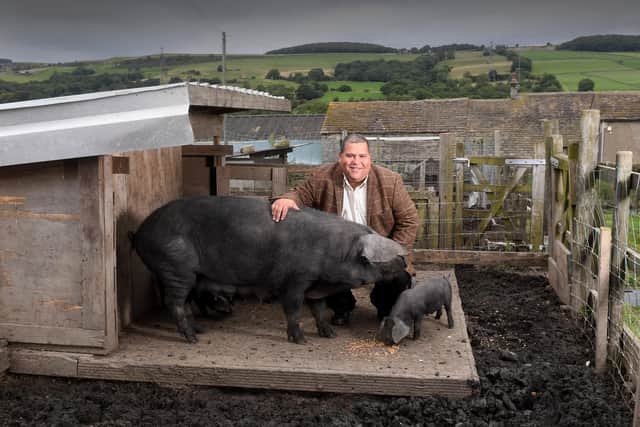 Lee Dunkley pictured with one of his Large Black pigs at Midhope Hall Farm, near Penistone