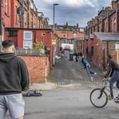 Young adults and children playing cricket in a back street of Leeds. PIC: Tony Johnson
