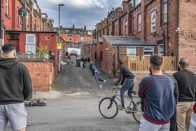 Young adults and children playing cricket in a back street of Leeds. PIC: Tony Johnson