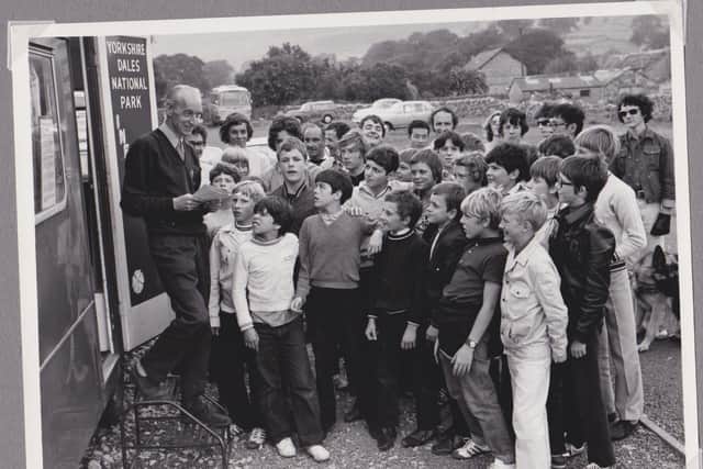 Wilf Proctor and a visiting school group at Malham with the caravan that acted as a mobile information centre across the Dales from 1965 Image courtesy Roger Widdup.