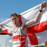 England's Tom Bosworth (silver) poses with his flag after the athletics men's 20m race walk final during the 2018 Gold Coast Commonwealth Games on the Gold Coast on April 8, 2018. (Picture: ADRIAN DENNIS/AFP via Getty Images)
