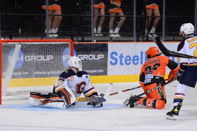 GO-AHEAD GOAL: Matt Petgrave backhands past Eamon McAdam from close range to make it 2-1 to Sheffield Steelers against Guildford Flame. Picture: Dean Woolley.