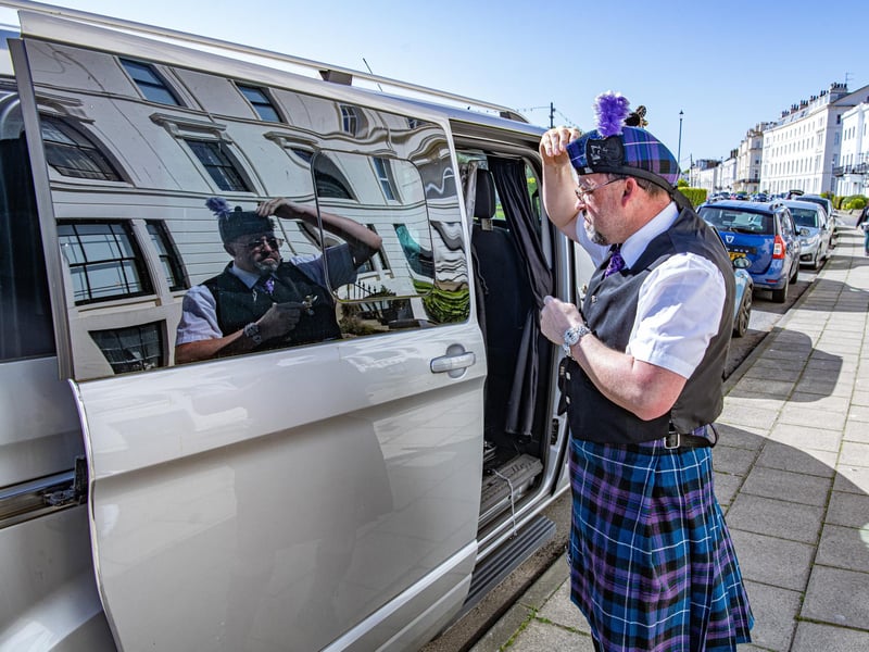 Colin Marris uses the reflection from his van to get ready