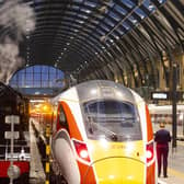 Flying Scotsman alongside the Azuma train reflecting the past and present trains of London North Eastern Railway (LNER) at King's Cross Station, London.