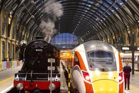 Flying Scotsman alongside the Azuma train reflecting the past and present trains of London North Eastern Railway (LNER) at King's Cross Station, London.