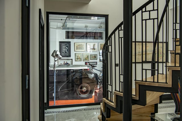 A huge glass window in the hallway offers a view of garage and Martin's classic cars and memorabilia