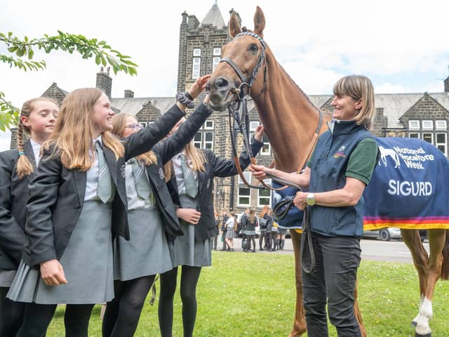 Racehorse Sigurd and trainer Jo Foster (right) meets children from Ilkley Grammar School in Ilkley ahead of National Racehorse Week last year. National Racehorse Week is a celebration of racehorses and the people that care for them, with events taking place at more than 150 venues across Great Britain during September: Richard Walker/PA Wire