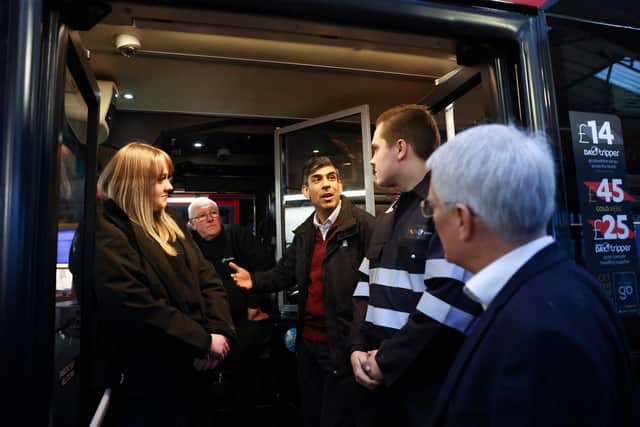 Prime Minister Rishi Sunak (centre) during his visit to a bus depot in Harrogate, North Yorkshire. PIC: Carl Recine/PA Wire