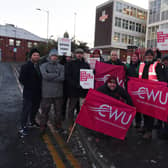 Members of the Communications Workers Union (CWU) and supporters picket outside a Royal Mail office.