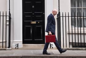 Chancellor John Healey poses for photographs as he leaves 11 Downing Street, London, before delivering his first Budget. PIC: Stefan Rousseau/Press Association