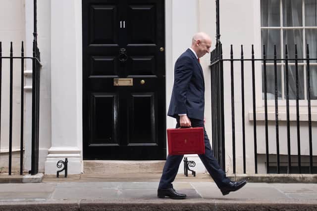 Chancellor John Healey poses for photographs as he leaves 11 Downing Street, London, before delivering his first Budget. PIC: Stefan Rousseau/Press Association
