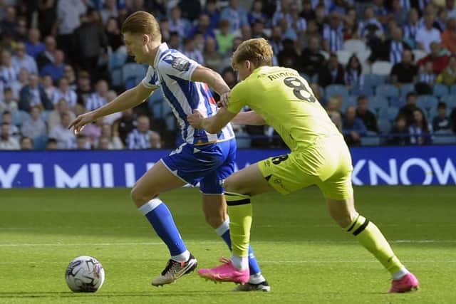 CLOSE ATTENTION: Huddersfield Town's Jack Rudoni gets to grips with George Byers