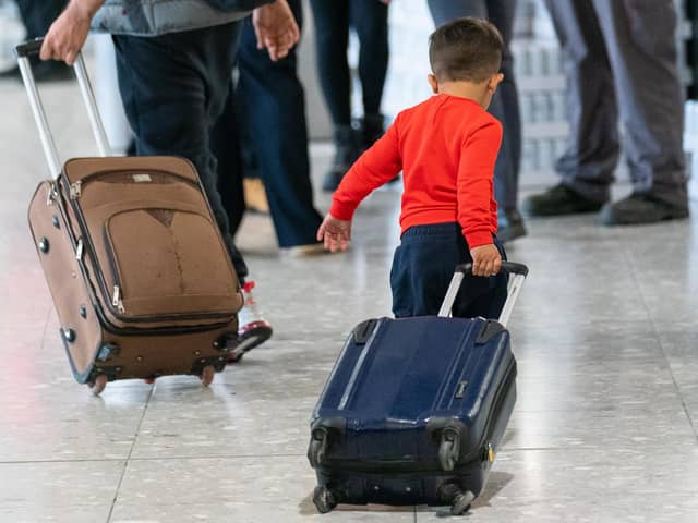 A young boy pulling a suitcase as refugees arrive from Afghanistan at Heathrow Airport, London. PIC: Dominic Lipinski/PA Wire