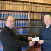 Hutchinson and Buchanan Partner, Richard Storey (left) presenting £300.00 cheque to James Parkes.