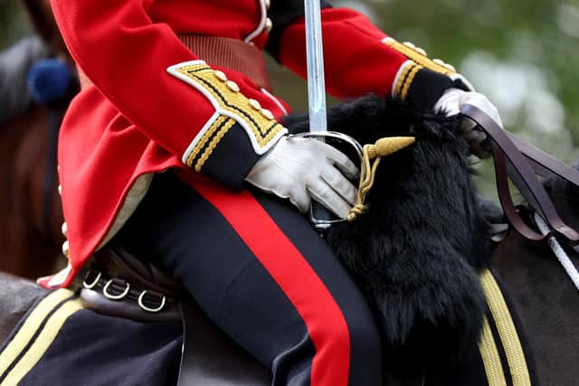 WINDSOR, ENGLAND - SEPTEMBER 19: A member of the Coldstream Guards ahead of the Committal Service for Queen Elizabeth II at Windsor Castle on September 19, 2022 in Windsor, England. The committal service at St George's Chapel, Windsor Castle, took place following the state funeral at Westminster Abbey. A private burial in The King George VI Memorial Chapel followed. Queen Elizabeth II died at Balmoral Castle in Scotland on September 8, 2022, and is succeeded by her eldest son, King Charles III. (Photo by Alex Pantling/Getty Images)