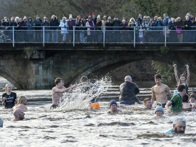 Hardy swimmers brave high water levels, a strong current and a water temperature of 6 degrees by taking part in the annual New Years Day Joe Town - Lilian Rickett Memorial Swim in the River Wharfe at Otley. Picture Tony Johnson