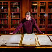 Jon Gilbert looks over the Martin Bell catalogue at the University of Leeds library. Picture: James Hardisty.