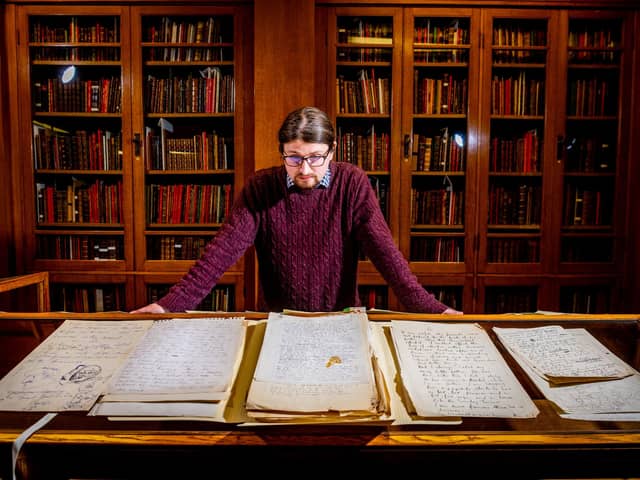 Jon Gilbert looks over the Martin Bell catalogue at the University of Leeds library. Picture: James Hardisty.