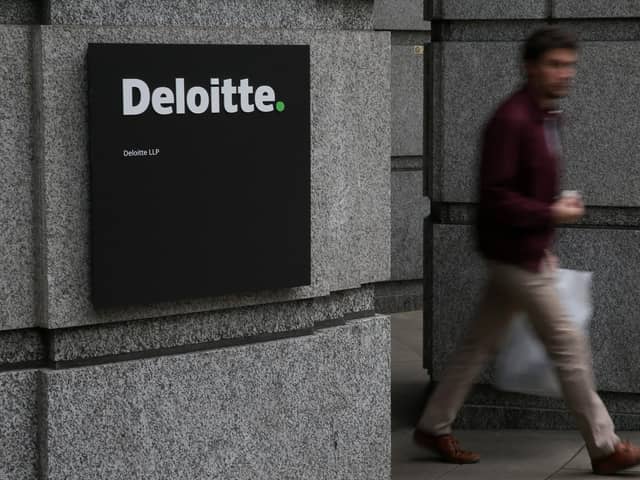A Deloitte logo is pictured on a sign outside the company's offices in London on September 25, 2017. (Photo by Daniel LEAL / AFP)