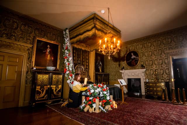 Alexa Buffey, Collections & House Manager decorating the casade of flowers in the Queens Room. Picture By Yorkshire Post Photographer,  James Hardisty.